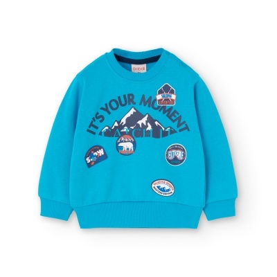 Sweatshirt azul turquesa com estampados de montanhas e patches