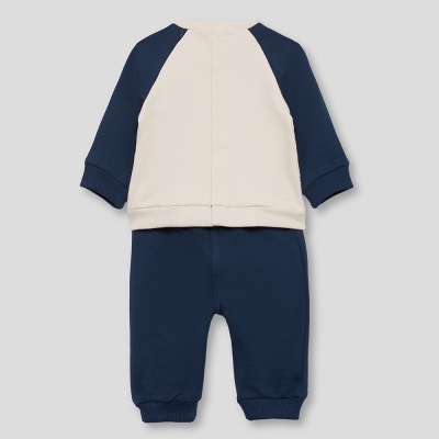 Conjunto de roupa de bebé azul-marinho e creme, visto das costas