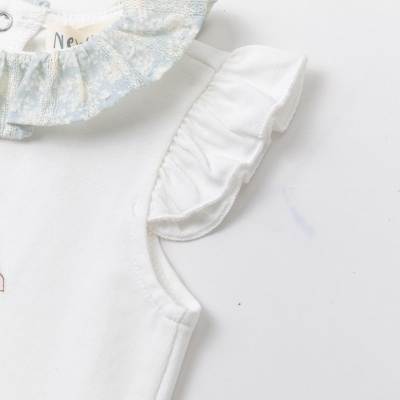 Roupa de bebé branca com gola azul floral e desenho de coelho