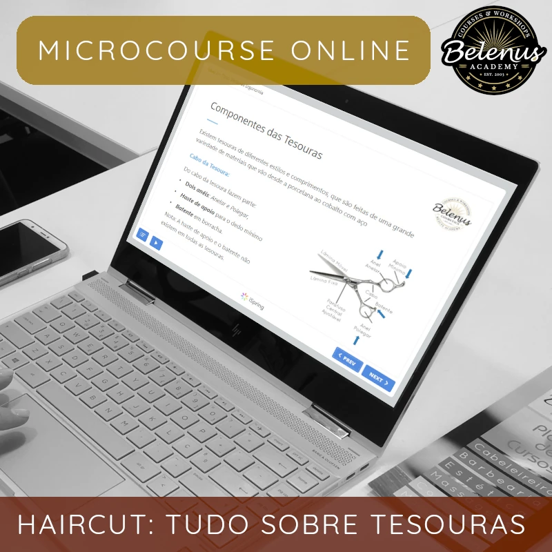 Microcurso Online: Tudo Sobre Tesouras Computador portátil prateado com ecrã mostrando curso online sobre tesouras, telemóvel e folhetos numa mesa branca