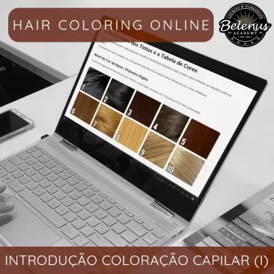 Computador portátil com tabela de cores de cabelo em ecrã e telemóvel ao lado numa mesa
