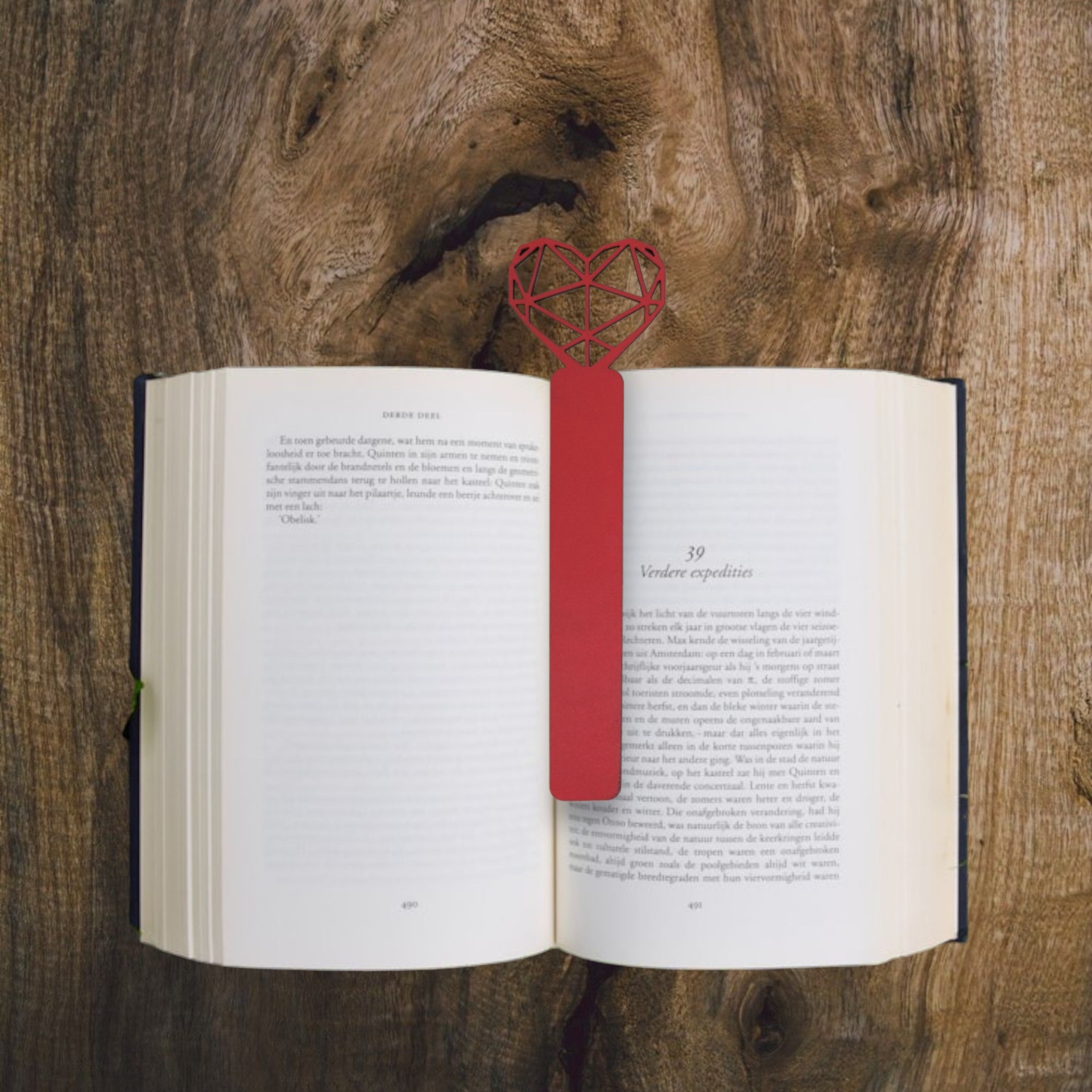 Marcador Coração Origami Livro aberto com marcador de página vermelho em forma de coração numa mesa de madeira