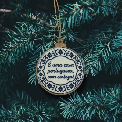 Decoração de Natal redonda com texto em português pendurada em árvore