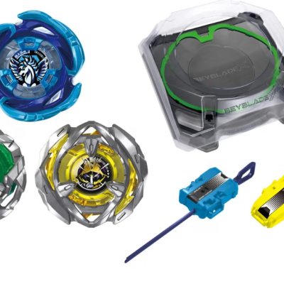 Beyblade spinning tops, arena, and launchers on white background