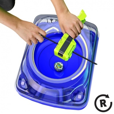Blue plastic Beyblade stadium with top and launcher in use