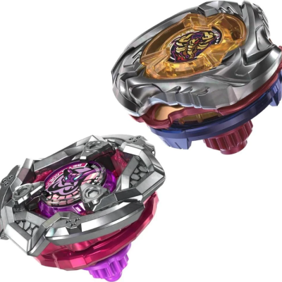 Two colorful spinning top toys with metallic and plastic parts, one featuring a scorpion emblem and yellow casing, the other with purple emblem and red frame.