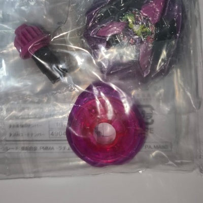 Three purple and pink plastic toy parts in a clear plastic bag