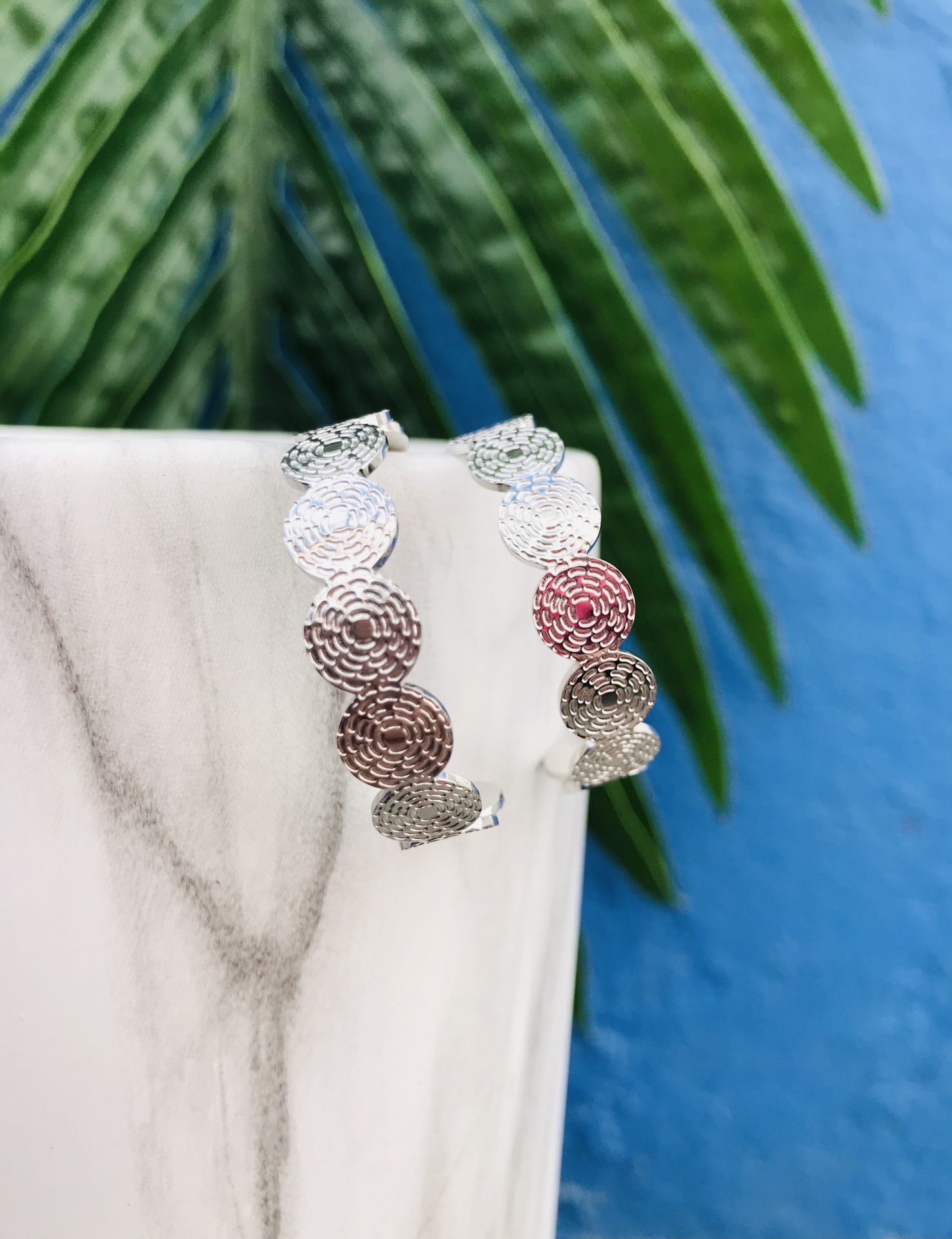 Brincos argola prateados com padrão circular texturizado