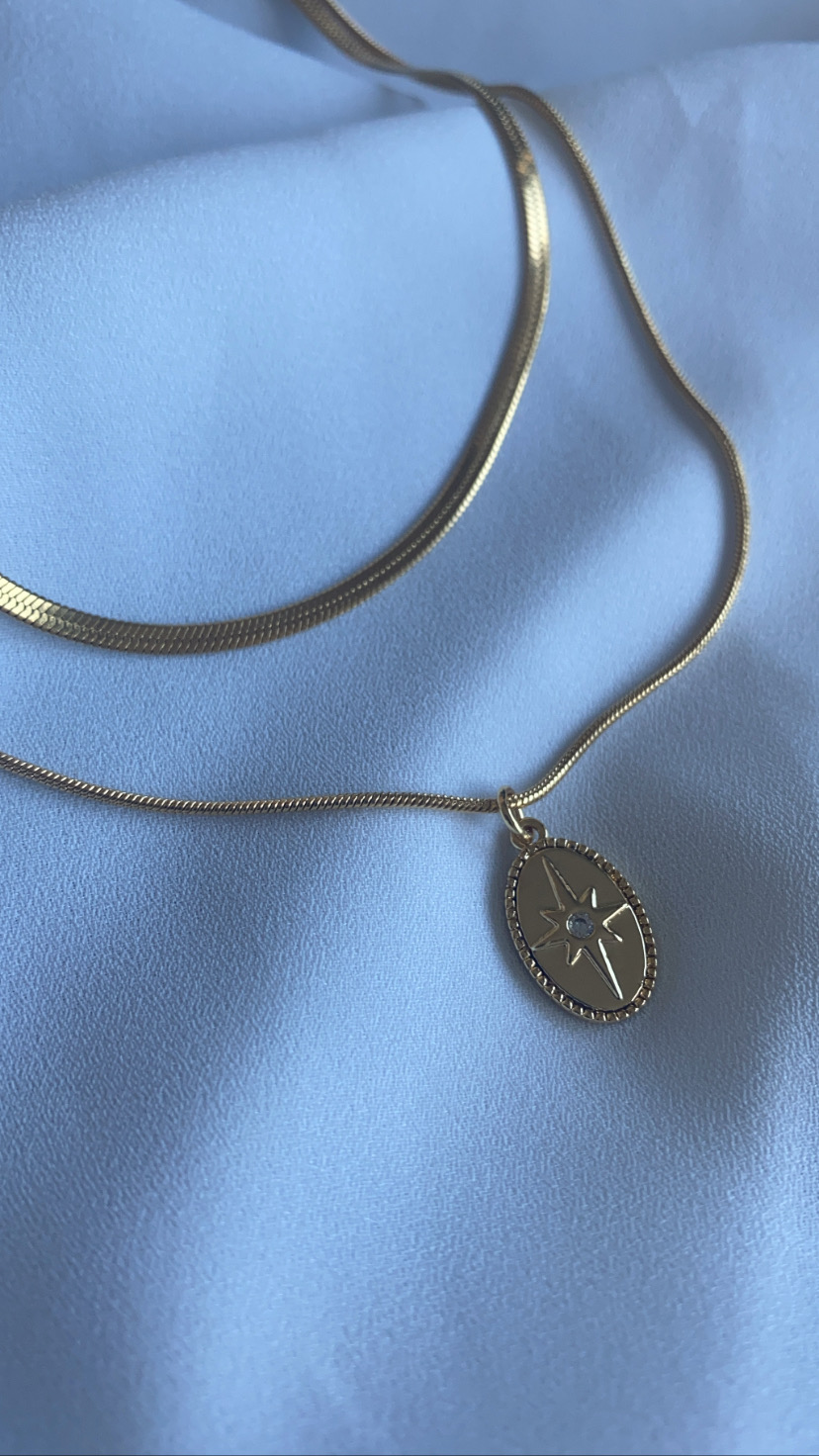 Colar duplo dourado com pendente oval com estrela e pequeno cristal