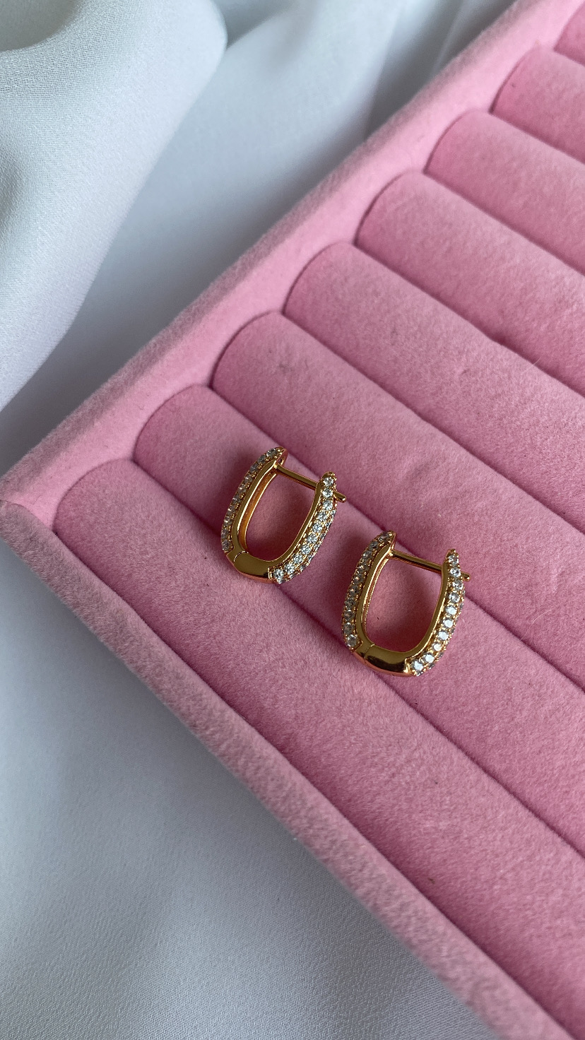 Brincos dourados com pedras em caixa rosa almofadada