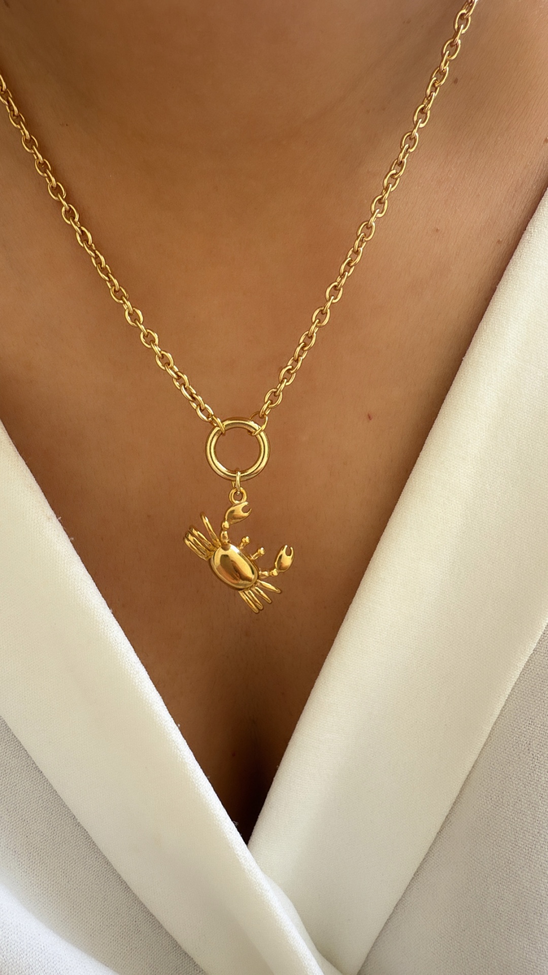 Colar dourado com pendente em forma de caranguejo