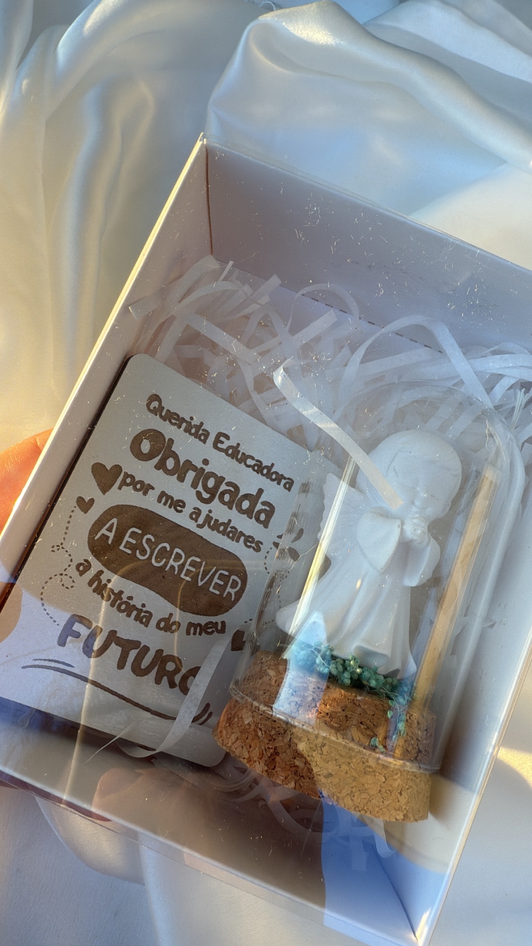 Caixa com figura branca e cartão com texto de agradecimento à educadora