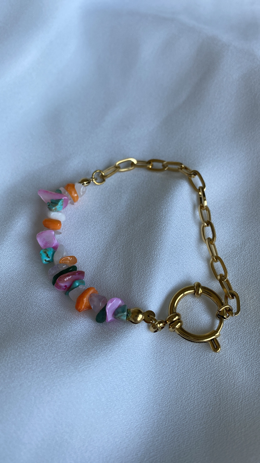 Pulseira dourada com pedras naturais coloridas em fundo branco
