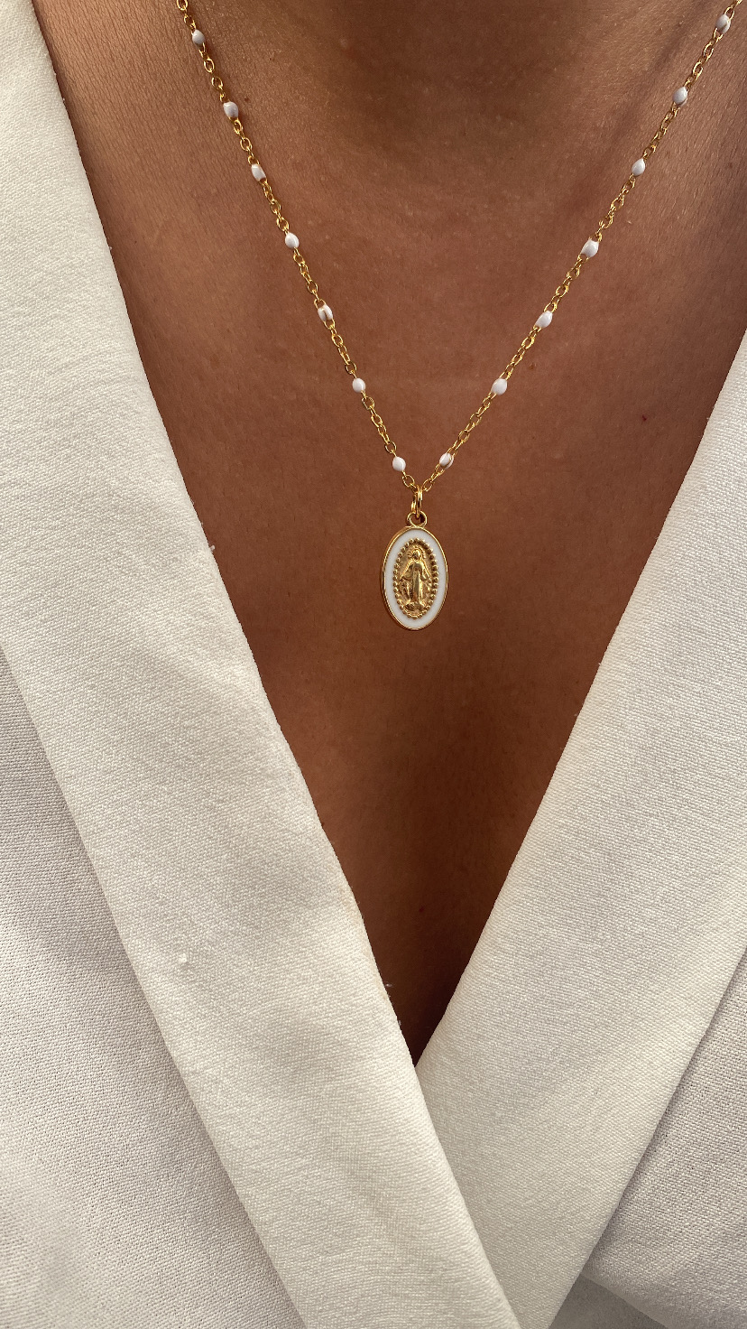 Colar dourado com pérolas e pendente oval religioso em fundo branco