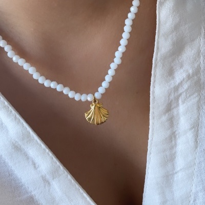 Colar branco com contas e pendente dourado em forma de concha