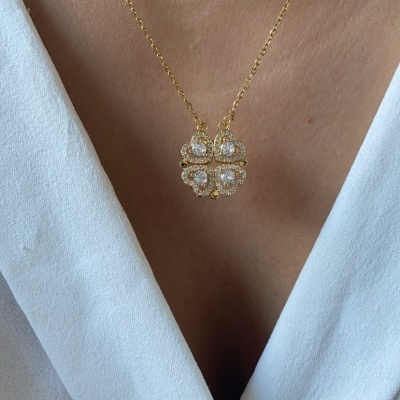 Colar dourado com pendente trevo e pedras brilhantes