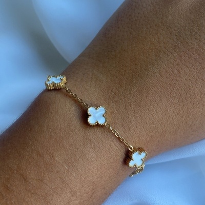Pulseira dourada com pendentes em forma de trevo de quatro folhas