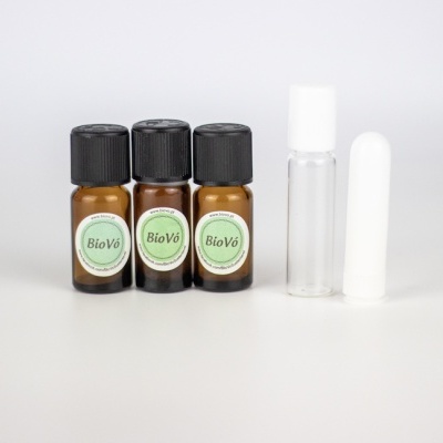 Três frascos pequenos BioVõ e dois frascos sem rótulo numa superfície branca.