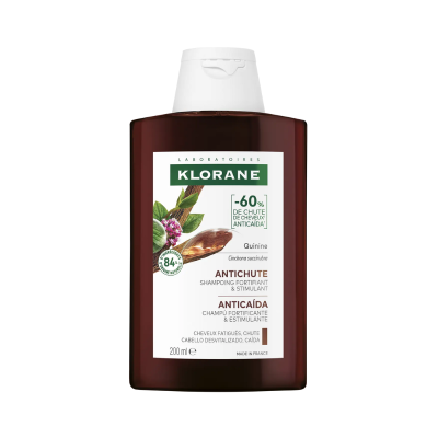 Frasco castanho de champô KLORANE com tampa branca e rótulo branco