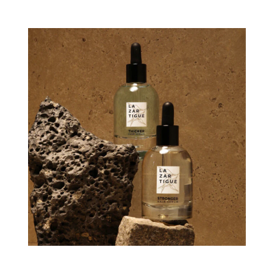Frascos de séruns capilares LAZARTIGUE com conta-gotas em pedras ásperas.
