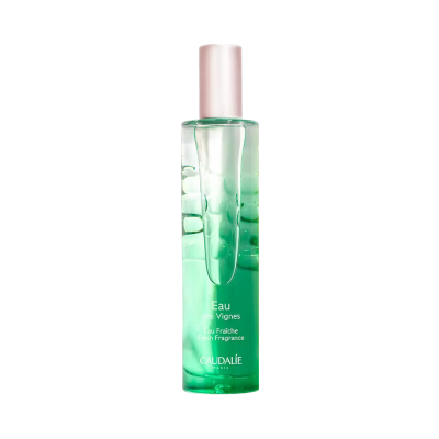 Frasco de perfume verde com tampa rosa e texto da marca Caudalie