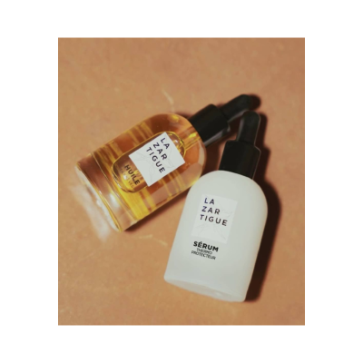 Dois frascos de sérum com conta-gotas, um amarelo e outro branco, rótulos LAZARTIGUE