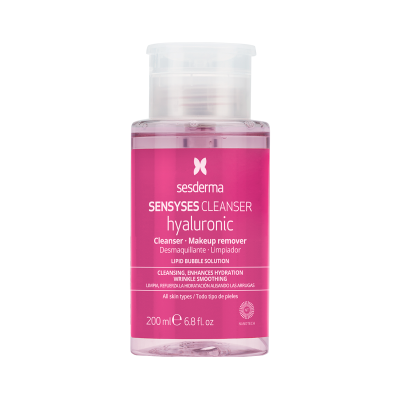 Frasco de plástico transparente com tampa branca contendo produto líquido rosa com rótulo rosa da marca Sesderma