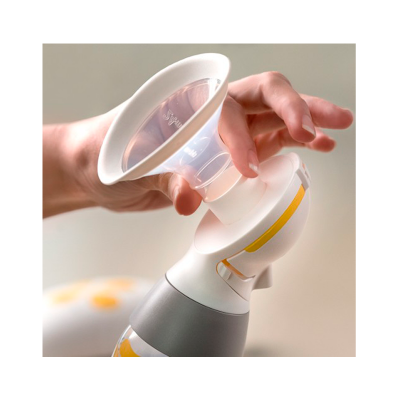 Bomba de leite elétrica branca com funil transparente e detalhes amarelos segura por uma mão