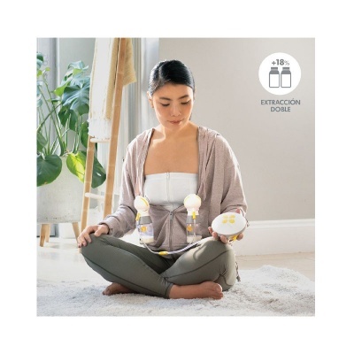 Mulher usando extrator duplo de leite materno sentado no tapete