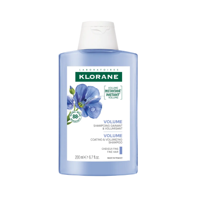 Frasco de champô Klorane Volume azul com tampa branca e rótulo com flor azul