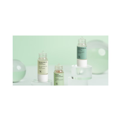 Frascos de produtos cosméticos com conta-gotas em fundo verde claro