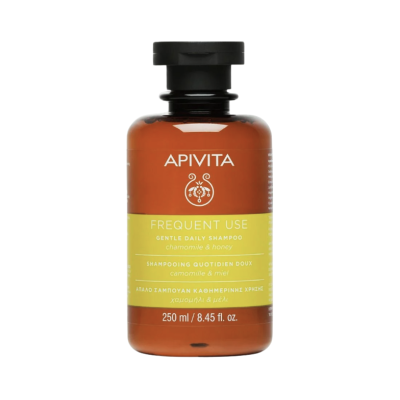 Frasco castanho de champô APIVITA Frequent Use com tampa preta e etiqueta verde e laranja