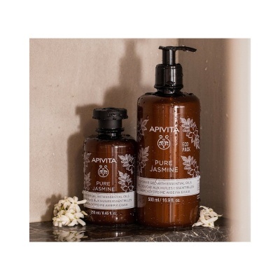 Duas embalagens castanho-escuro de gel de duche APIVITA Pure Jasmine com ilustrações florais brancas