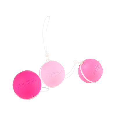 Três bolas rosas com cordões e a palavra INTIMINA gravada, sobre fundo branco