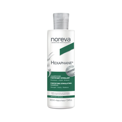 Frasco branco de shampoo Noreva Hexaphane com rótulo verde e branco