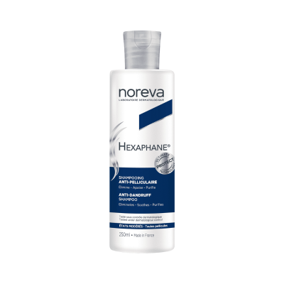 Frasco branco de shampoo anti-caspa Noreva Hexaphane com rótulo azul e branco