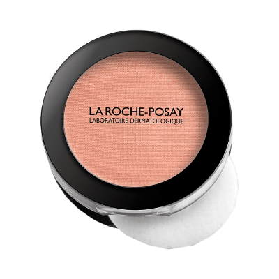 Blush compacto cor de pêssego da La Roche-Posay com tampa preta e embalagem transparente