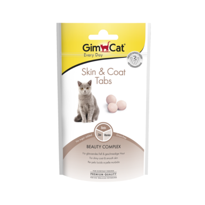 Embalagem de comprimidos para gatos GimCat Skin & Coat Tabs, branco com amarelo, imagem de gato cinzento e comprimidos rosa claro