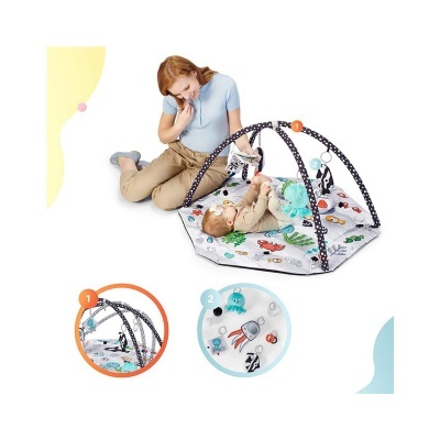 Tapete de atividades para bebé com padrão de carros e estruturas arqueadas com brinquedos pendurados