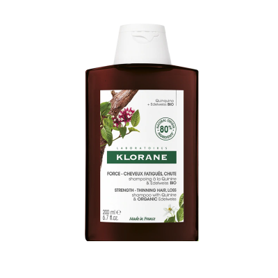 Frasco de shampoo Klorane castanho com rótulo branco