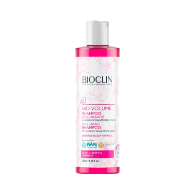 Frasco de shampoo volumizante BIOCLIN com tampa rosa e rótulo branco e rosa