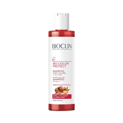 Frasco de shampoo Bioclin Bio-Color Protect vermelho com texto em branco.