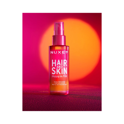 Frasco rosado de spray para cabelo e pele da marca NUXE