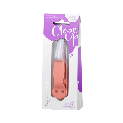 Suporte de chucha rosa com fita riscada em embalagem branca e roxa