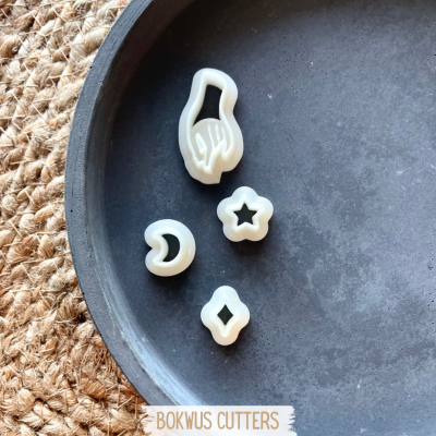 Conjunto de cortadores de massa branco em bandeja preta sobre juta com texto BOKWUS CUTTERS