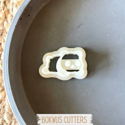 Cortador de bolachas branco em forma de coelho dentro de uma tigela cinzenta