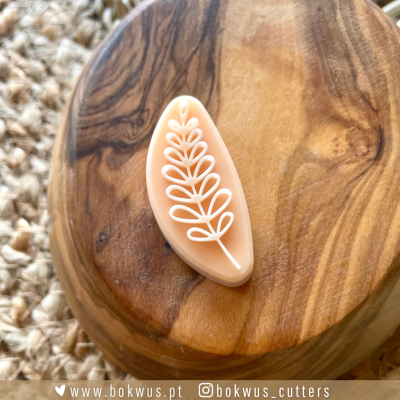 Cortante de massa com design de folha sobre base de madeira