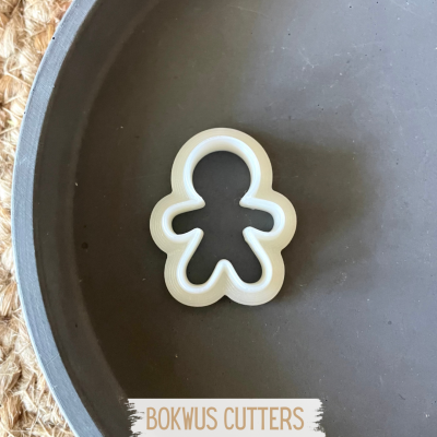 Cortador de bolachas forma boneco plástico branco em forma metal escura