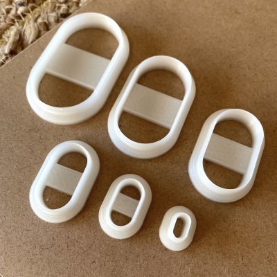 Conjunto de seis moldes ovais brancos de plástico com faixa horizontal no centro