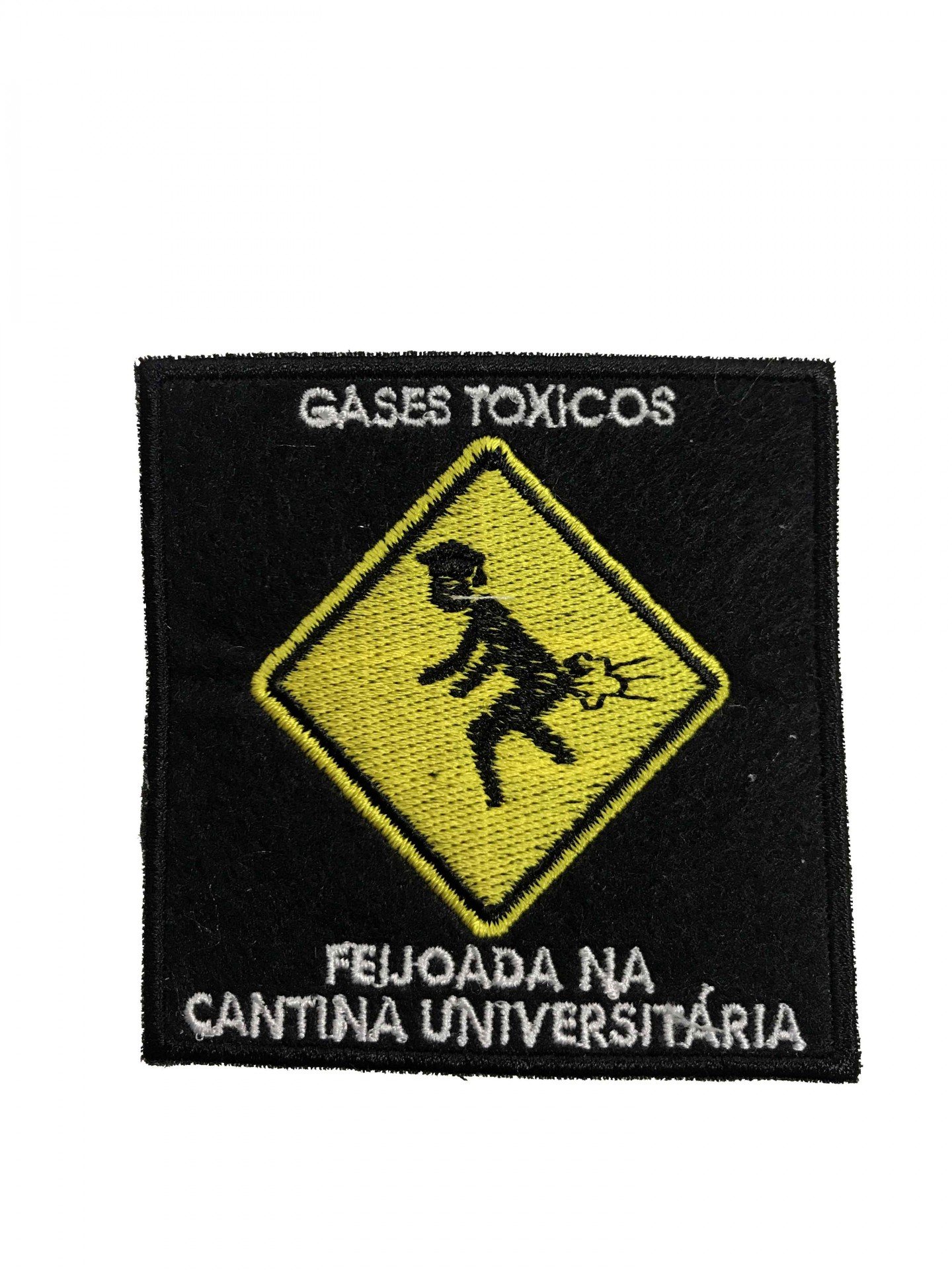 Patch de tecido preto com bordado amarelo e branco sobre gases tóxicos